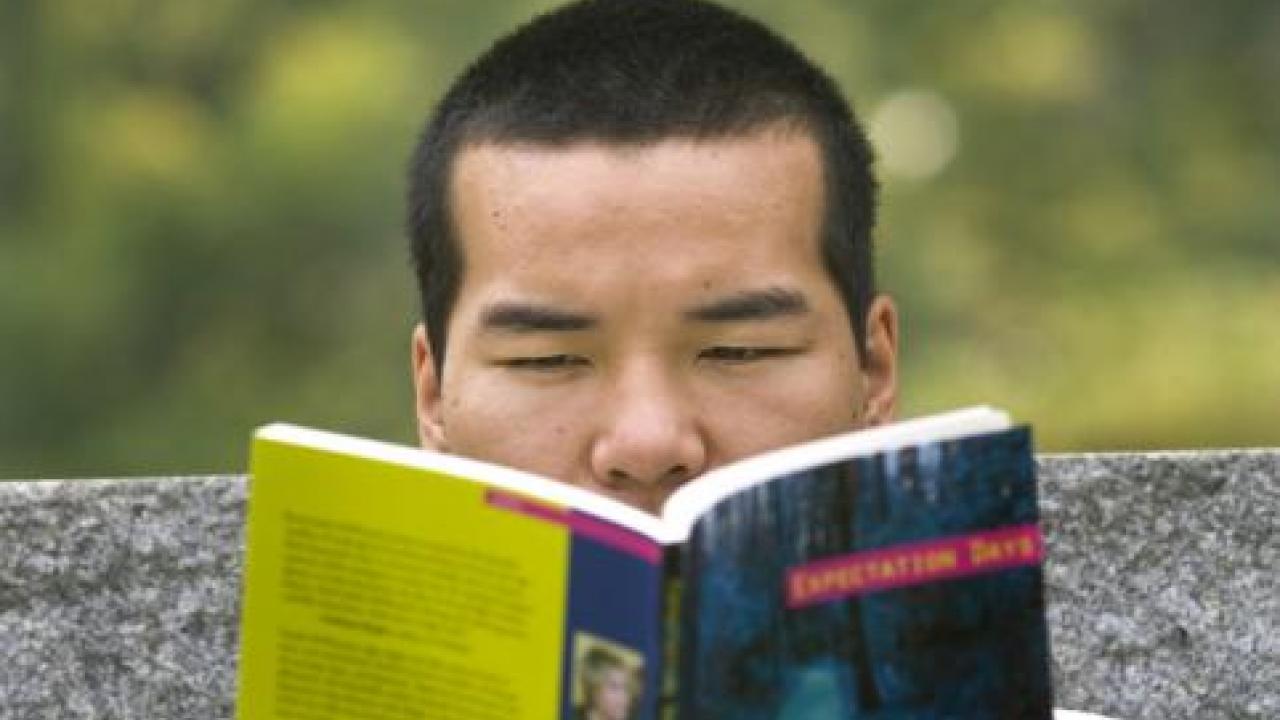 Student reading arboretum