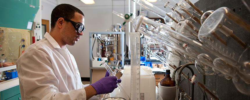 Pharmaceutical chemistry major Manuel Munoz ’13 prepares a liquid solution for his intern project on cancer research, getting research experience that graduate programs are seeking. (Gregory Urquiaga/UC Davis)