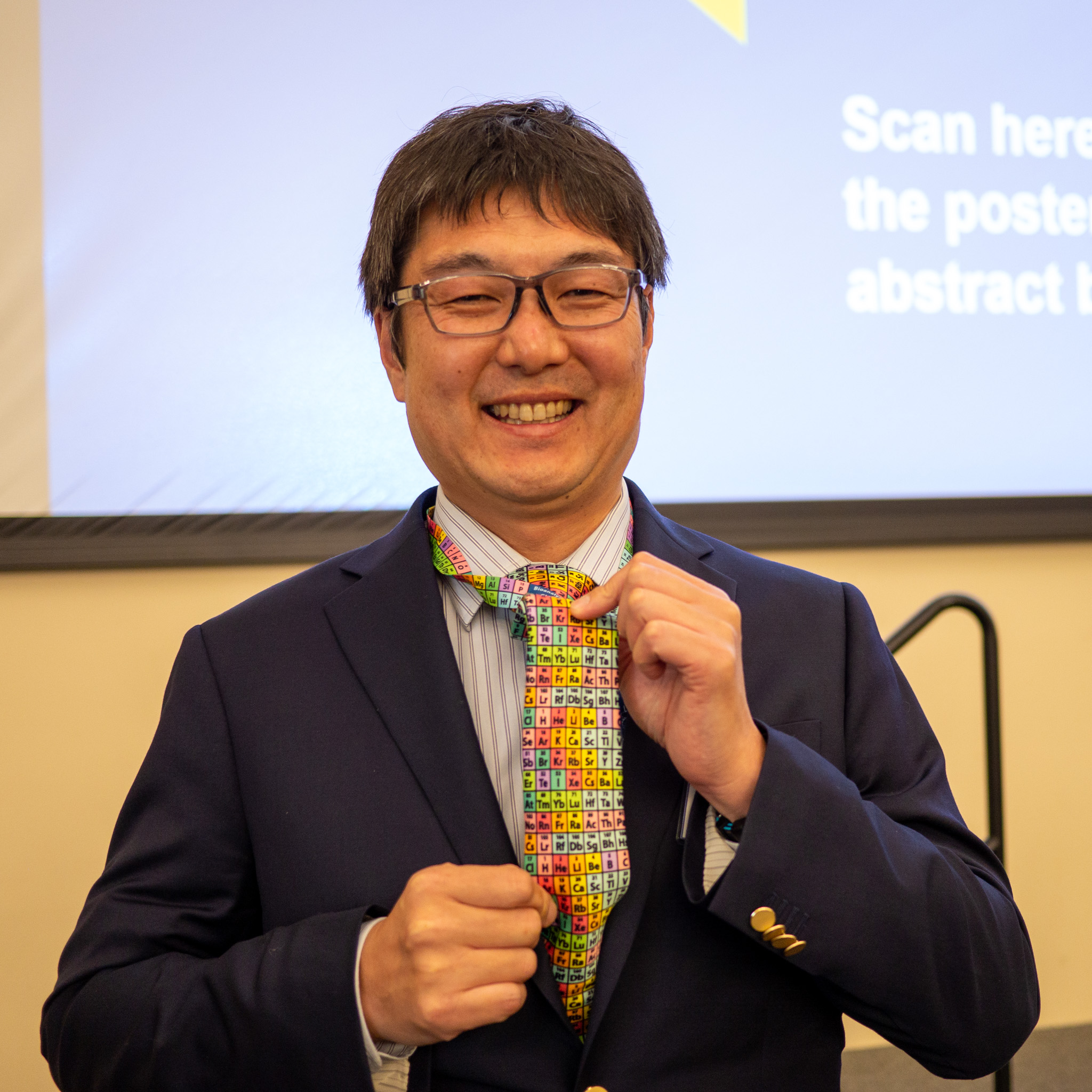 Shota Atsumi shows off his periodic table-themed tie. 