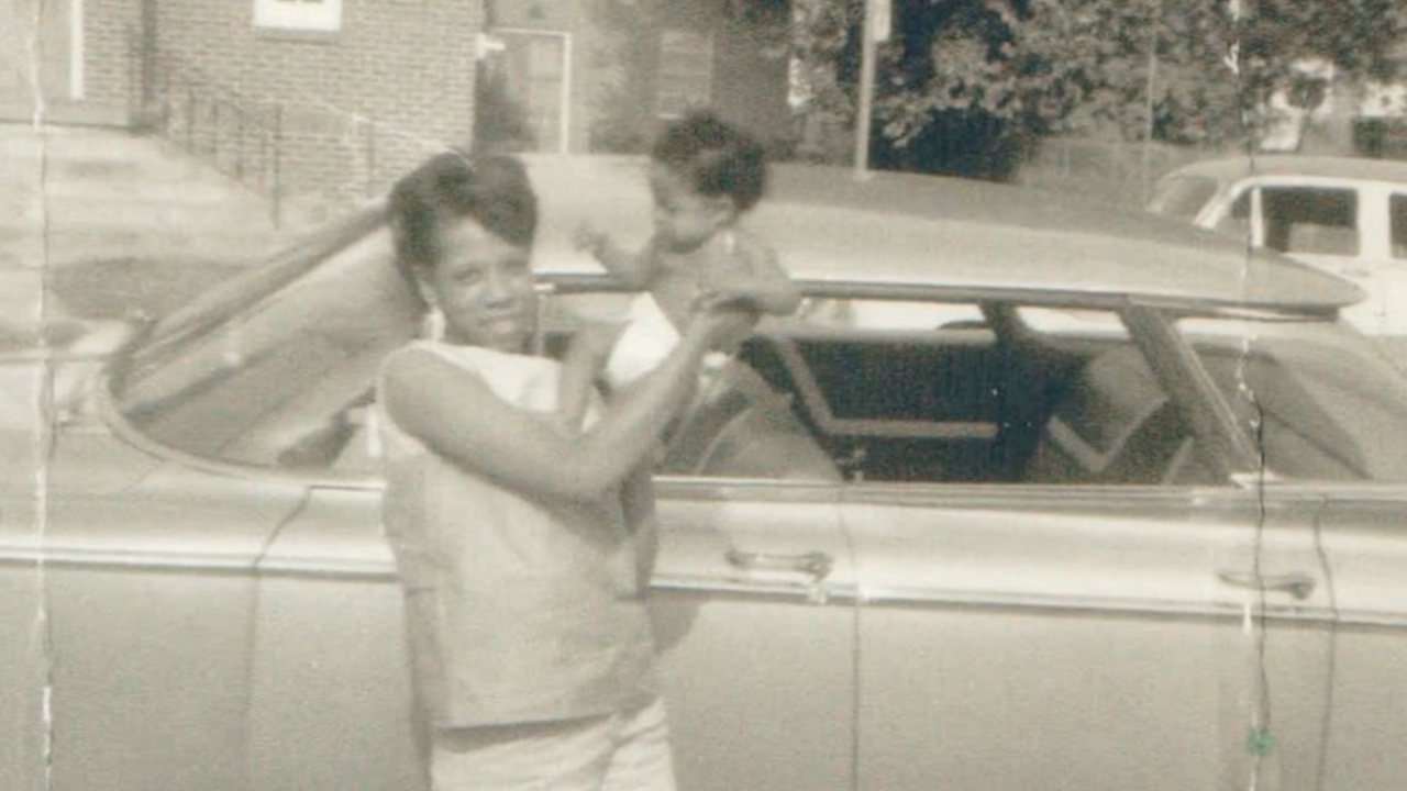 Snapshot of faculty member Milmon Harrison as a baby with his mother