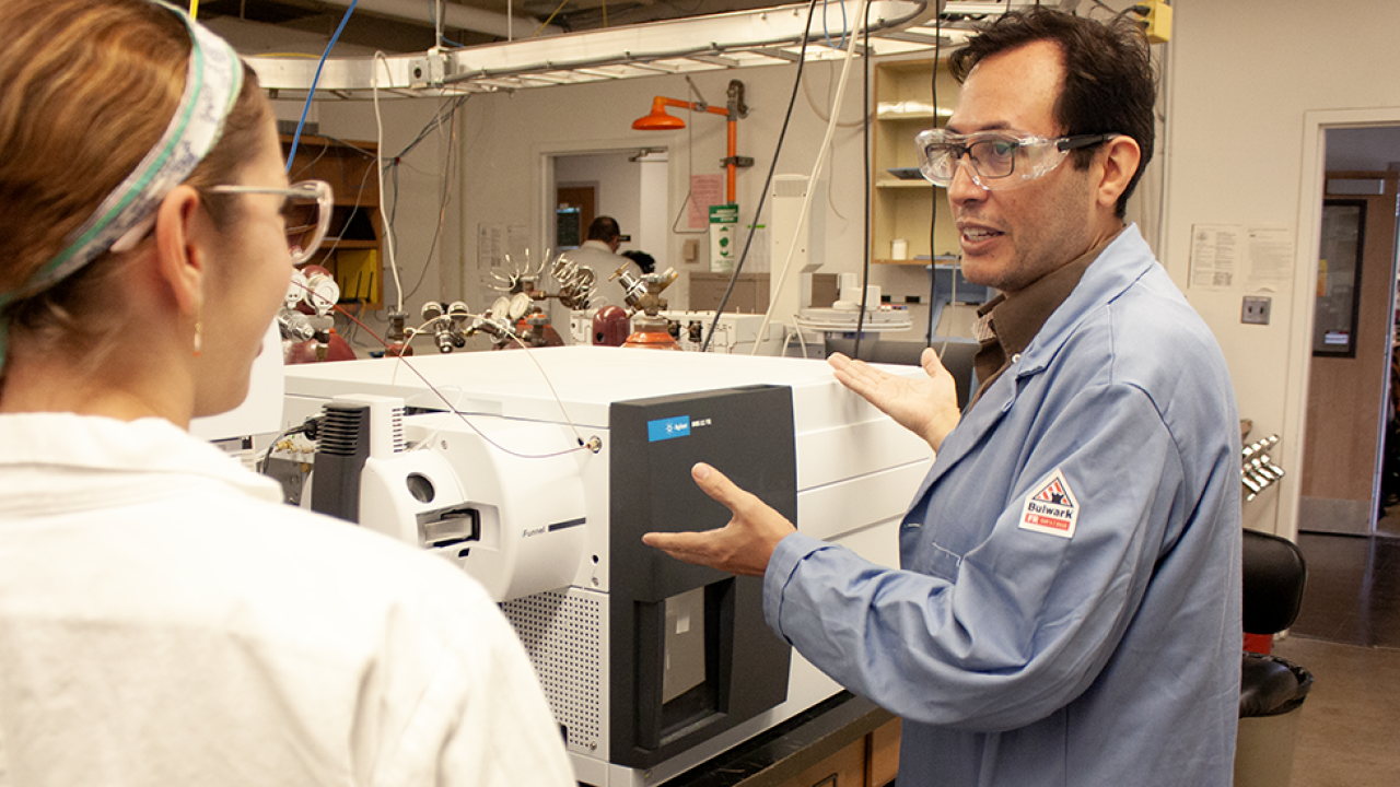 Javier Aztiazarain, doctoral student in chemistry, shows another student the new Agilent 6495 LC/TQ mass spectrometer