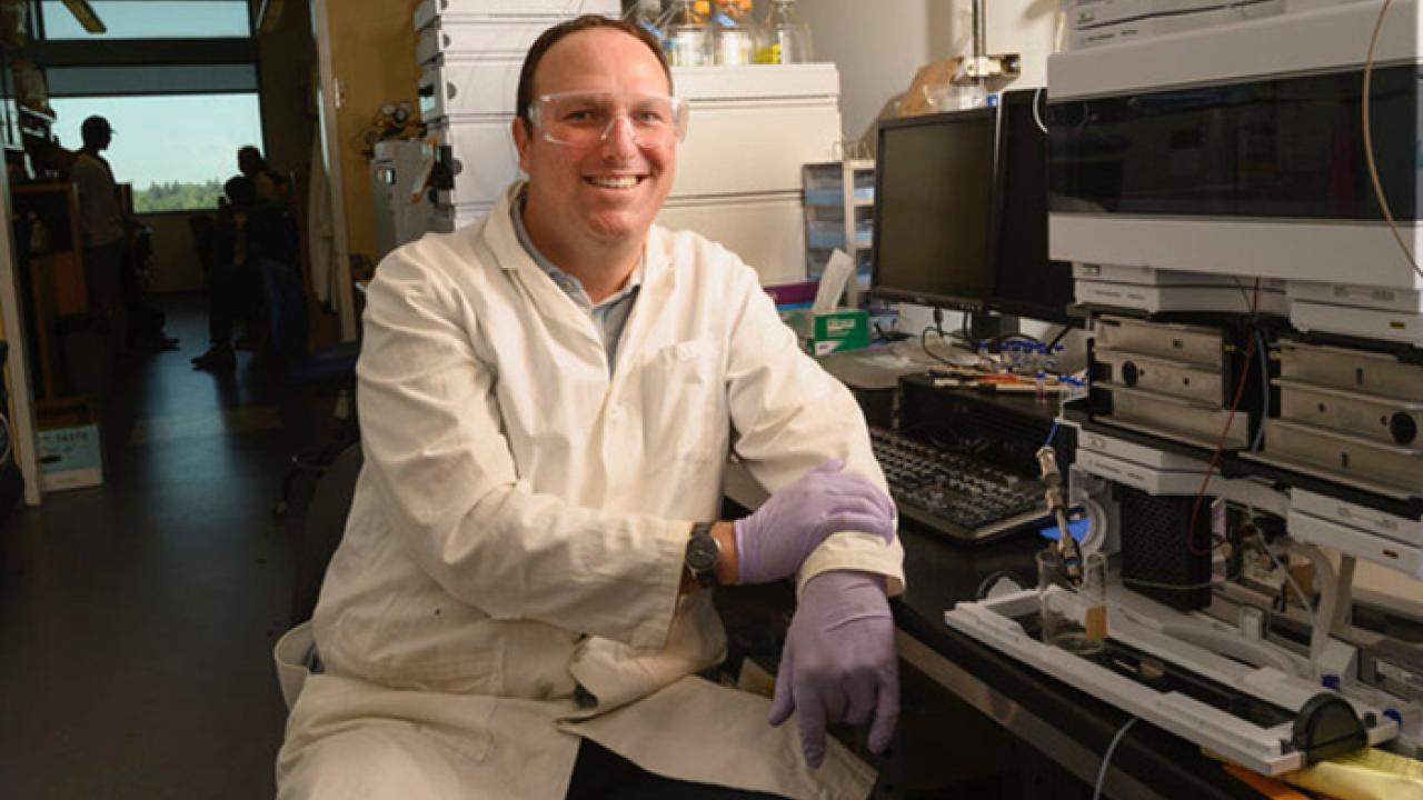Justin Siegel sits in a lab. 