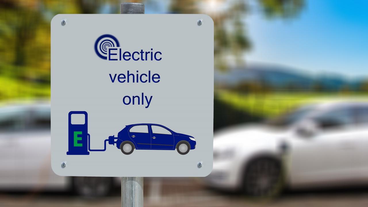 Street sign for charging station that reads "Electric Vehicle Only"