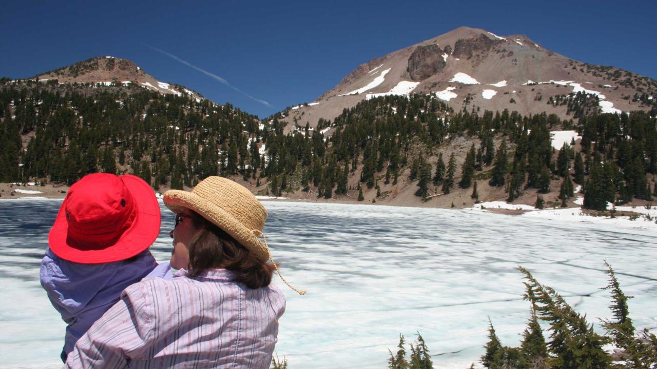 A woman and a child take in a view at Lassen Volcanic National Park. Thanks to research by UC Davis historians, national parks in the West and Pacific now have more information available online on women who played roles in establishing or maintaining 64 park sites. (Getty Images).