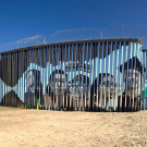Mexico/U.S. border wall with mural organized by UC Davis student