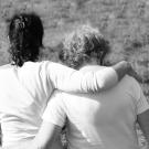 Photo: backs of young woman with arm wrapped around older woman