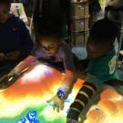 Children play with the UC Davis AR Sandbox
